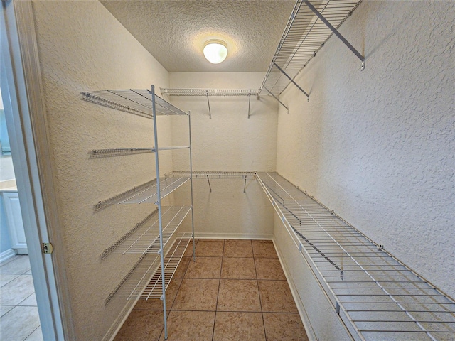 spacious closet with tile patterned floors