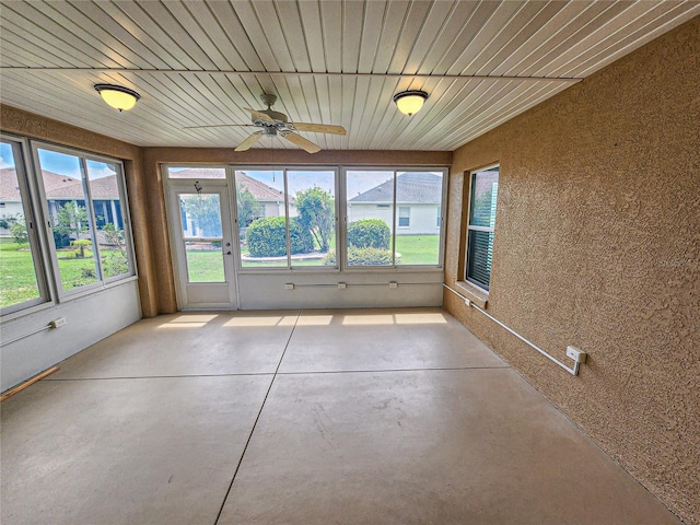 unfurnished sunroom with ceiling fan