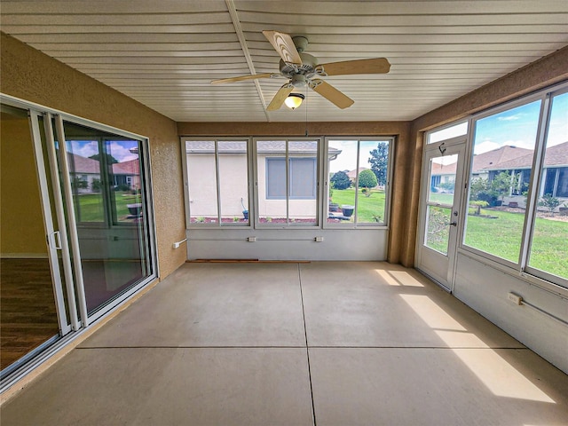 unfurnished sunroom with ceiling fan and a healthy amount of sunlight