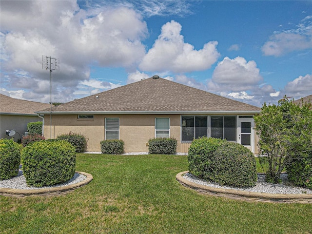 rear view of property with a yard