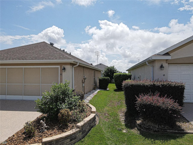 view of side of home with a garage and a yard