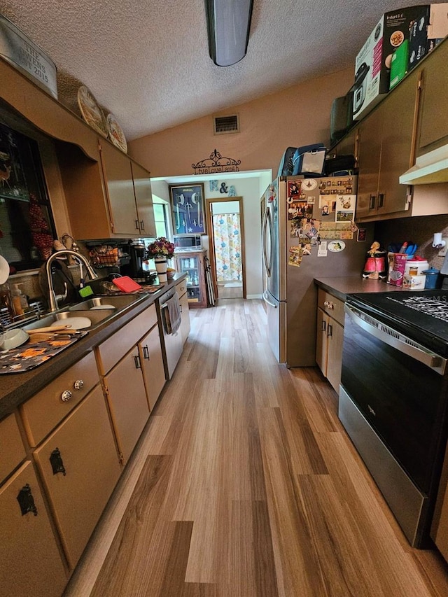 kitchen featuring sink, stainless steel appliances, ventilation hood, a textured ceiling, and light wood-type flooring