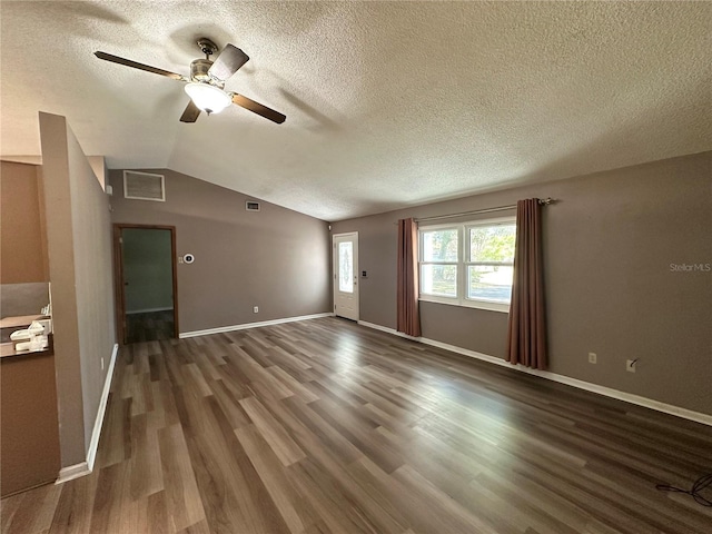 unfurnished living room featuring visible vents, baseboards, lofted ceiling, and wood finished floors