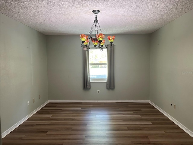 unfurnished room featuring a textured ceiling, baseboards, and dark wood-style flooring