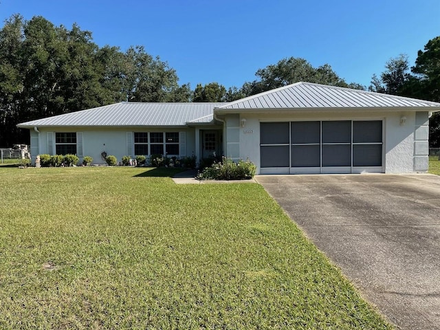 ranch-style house with a garage and a front lawn