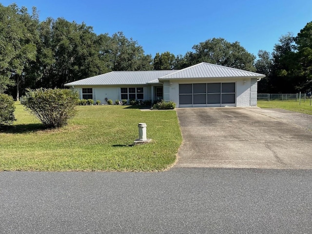 ranch-style home featuring a garage and a front lawn