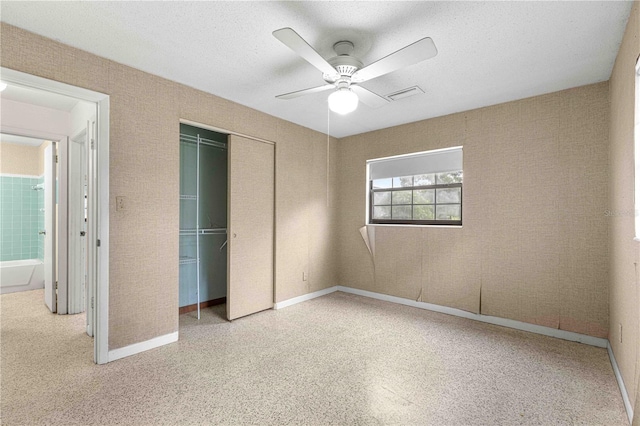 unfurnished bedroom featuring a textured ceiling, a closet, and ceiling fan