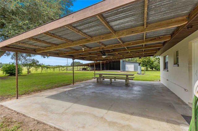 view of patio featuring a garage and an outbuilding