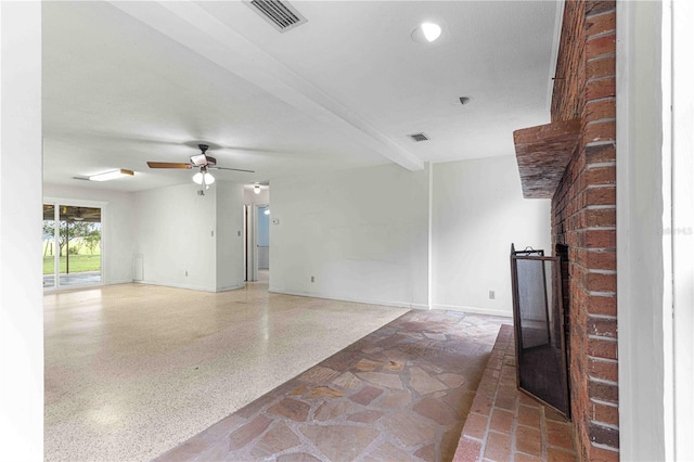 unfurnished living room featuring beamed ceiling and ceiling fan