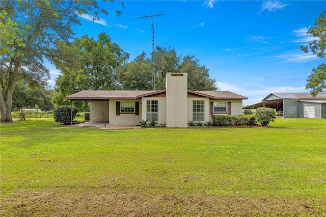 rear view of property with a yard