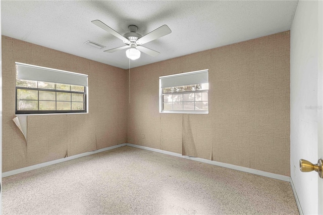 unfurnished room featuring a textured ceiling and ceiling fan