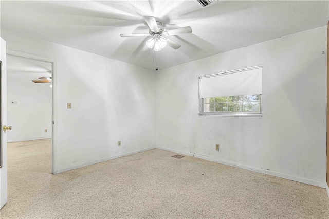 empty room featuring a textured ceiling and ceiling fan