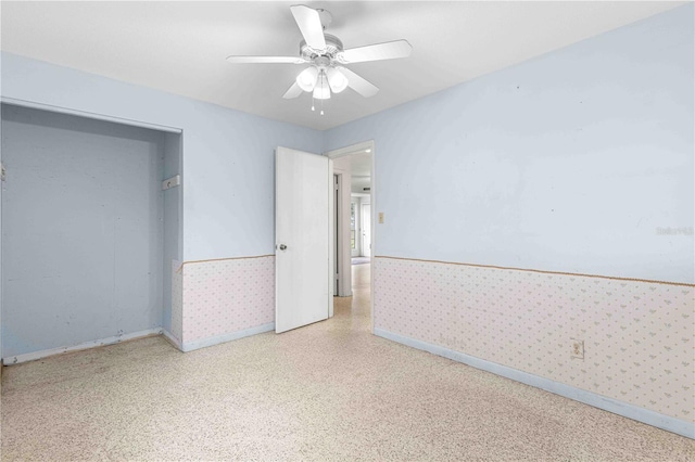 unfurnished bedroom featuring ceiling fan