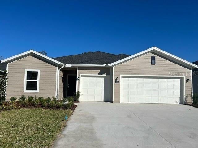 ranch-style home featuring a garage