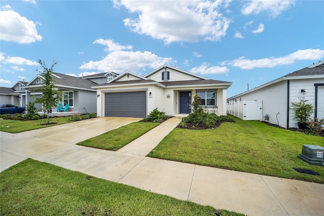 ranch-style house featuring a front yard and a garage