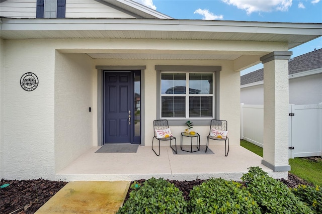 doorway to property featuring covered porch