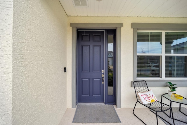 entrance to property featuring covered porch