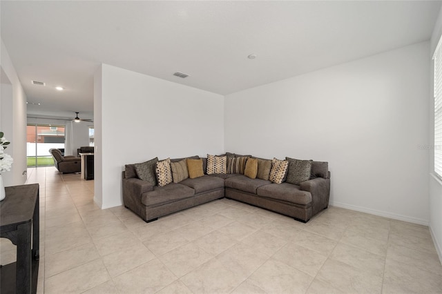 living room featuring light tile patterned flooring and ceiling fan