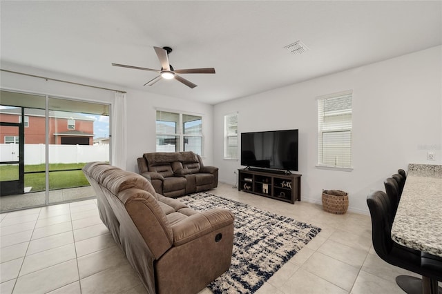 tiled living room with ceiling fan