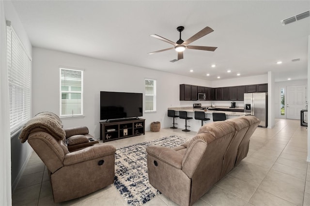 living room with light tile patterned flooring and ceiling fan