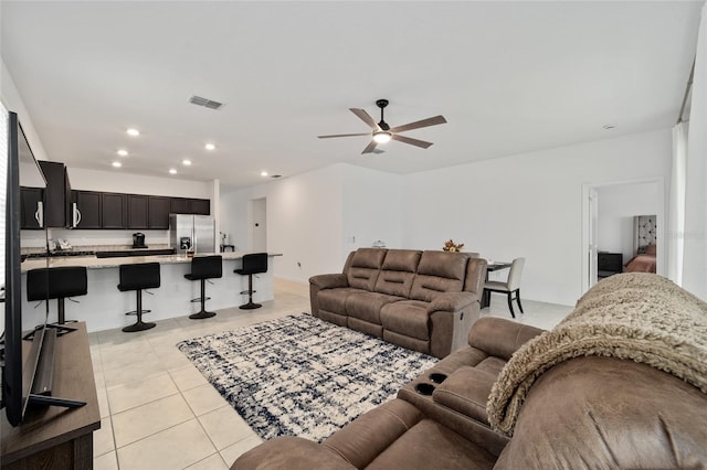 living room with ceiling fan and light tile patterned floors