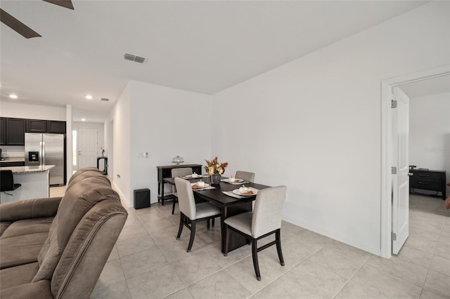 tiled dining space with ceiling fan