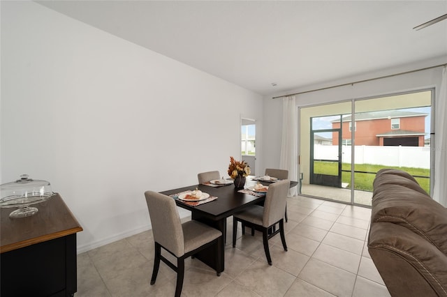 dining space featuring light tile patterned floors