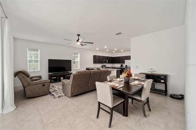 tiled dining room featuring ceiling fan