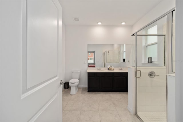 bathroom with vanity, toilet, walk in shower, tile patterned flooring, and a healthy amount of sunlight