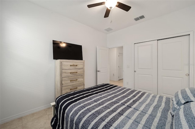 tiled bedroom featuring ceiling fan and a closet