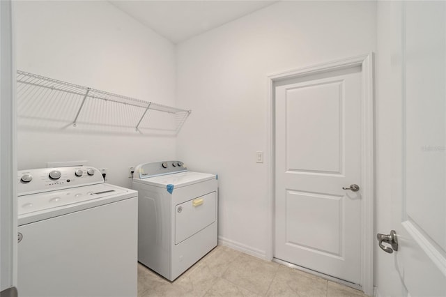 laundry area featuring light tile patterned flooring and independent washer and dryer