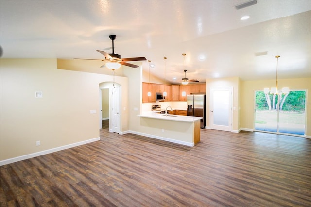 unfurnished living room with ceiling fan with notable chandelier, lofted ceiling, dark hardwood / wood-style flooring, and sink