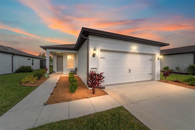 view of front of home featuring a yard and a garage