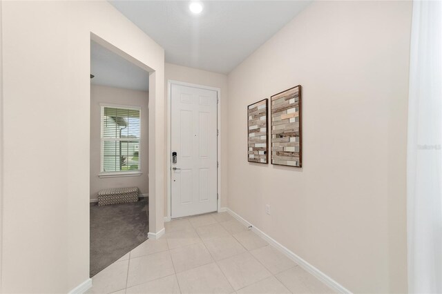 hallway featuring light carpet