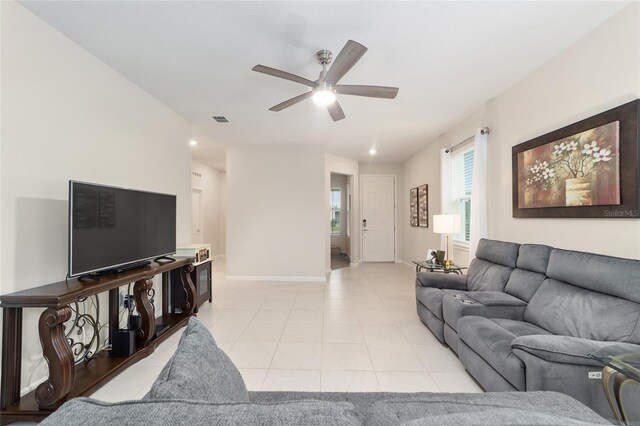 tiled living room featuring ceiling fan