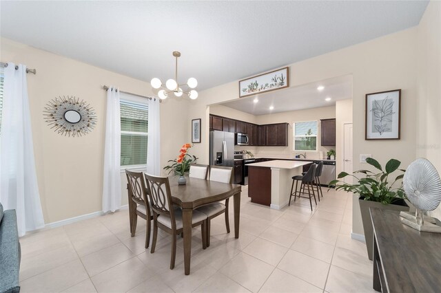 dining space with a notable chandelier and light tile patterned floors