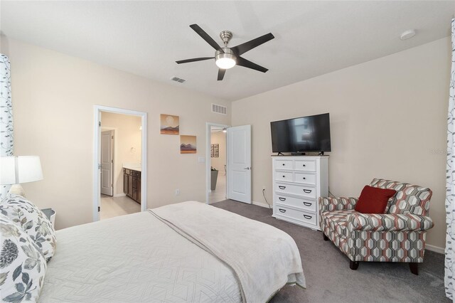 carpeted bedroom with ceiling fan and ensuite bathroom