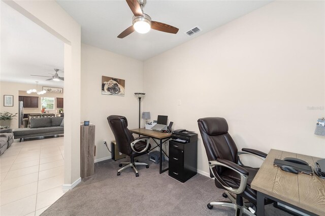 carpeted office with ceiling fan with notable chandelier