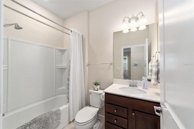 full bathroom with vanity, shower / tub combo, and toilet