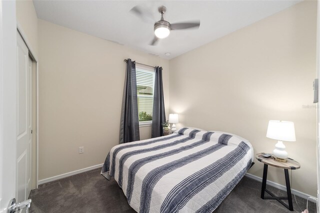 carpeted bedroom with ceiling fan and a closet