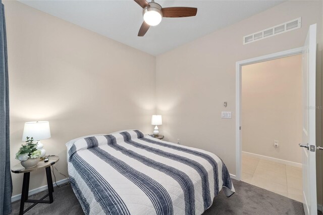 bedroom with ceiling fan and tile patterned floors