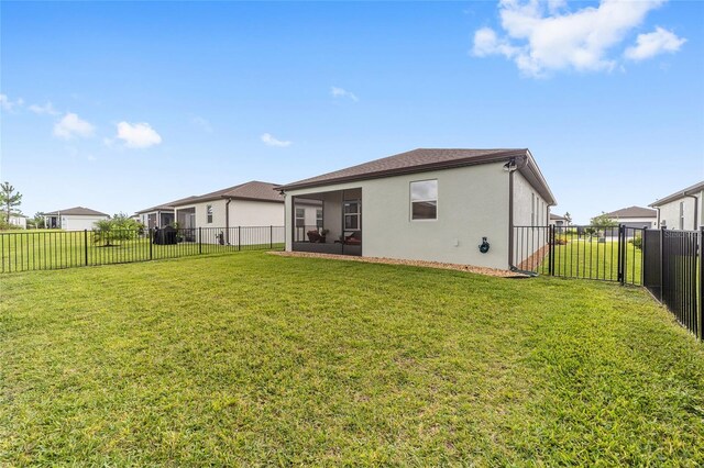 rear view of house with a lawn