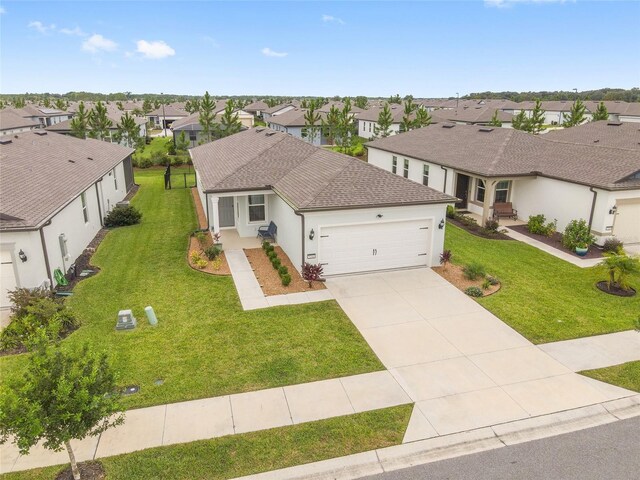 view of front of house with a garage and a front lawn