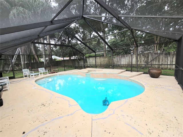 view of swimming pool with a lanai and a patio area