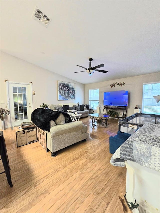 living room featuring light hardwood / wood-style flooring and ceiling fan