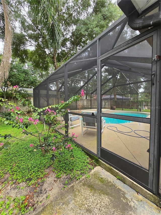 view of vehicle parking featuring a fenced in pool