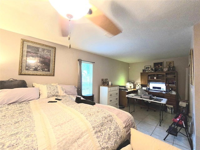 tiled bedroom with a textured ceiling