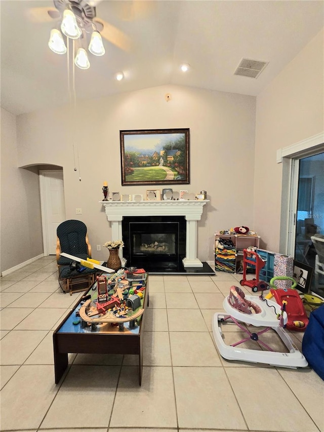 living room featuring tile patterned floors, ceiling fan, and lofted ceiling