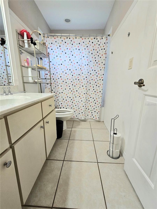 bathroom featuring tile patterned floors, vanity, and toilet