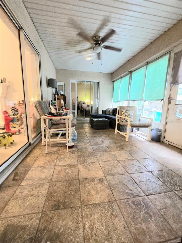 unfurnished sunroom featuring ceiling fan and wooden ceiling